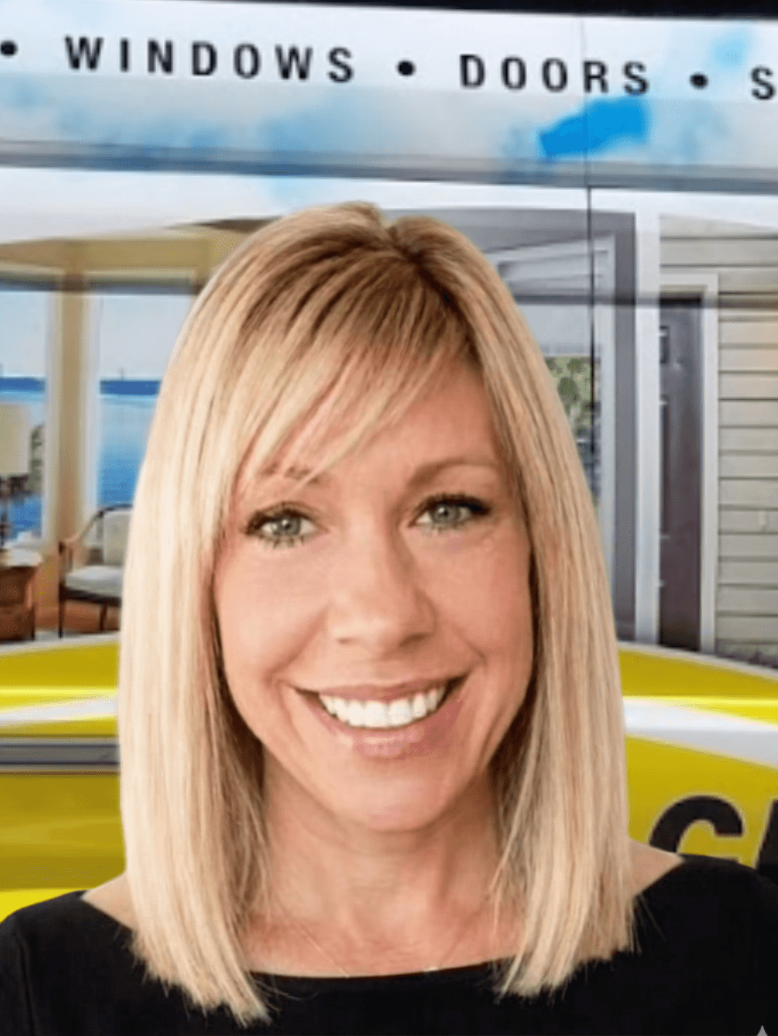 Smiling woman with blonde hair in front of windows and doors showroom display